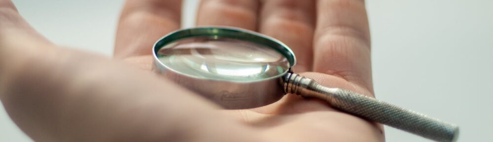 selective focus photo of magnifying glass